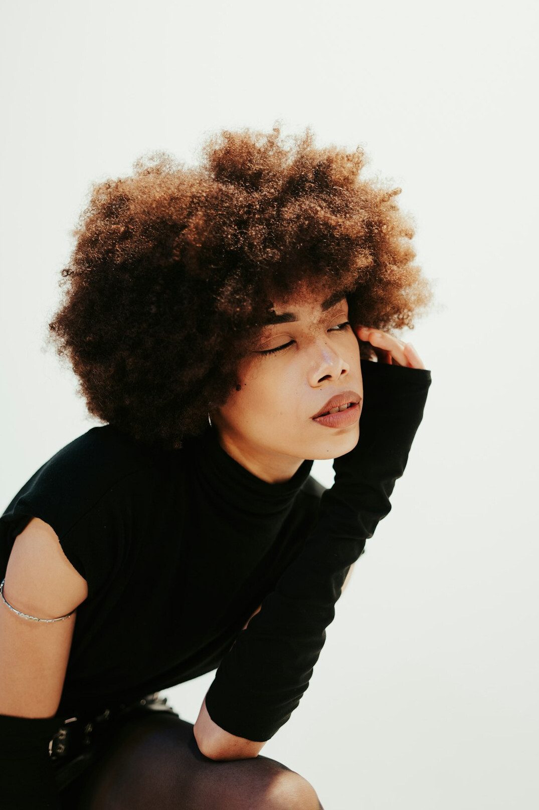 Studio portrait of a young woman with curly hair